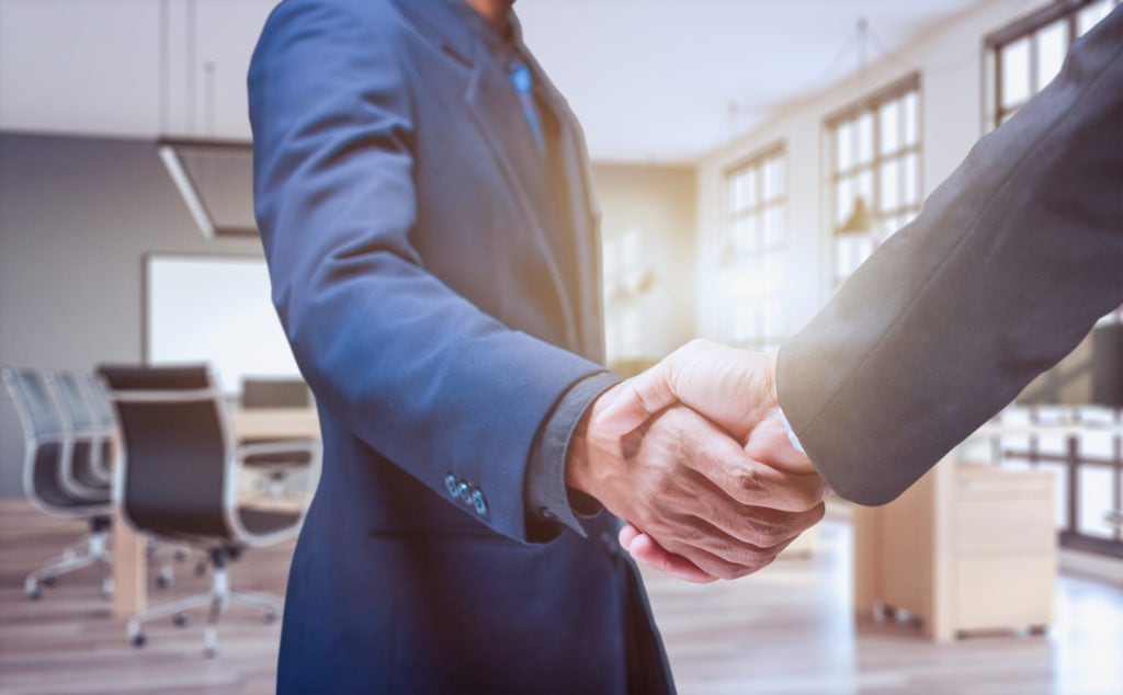 Business people shake hands in the office - Image