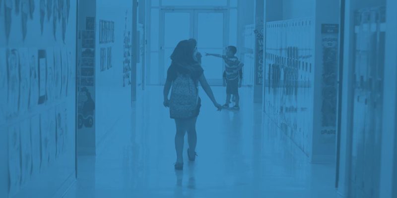 Young girl walking through a school hallway