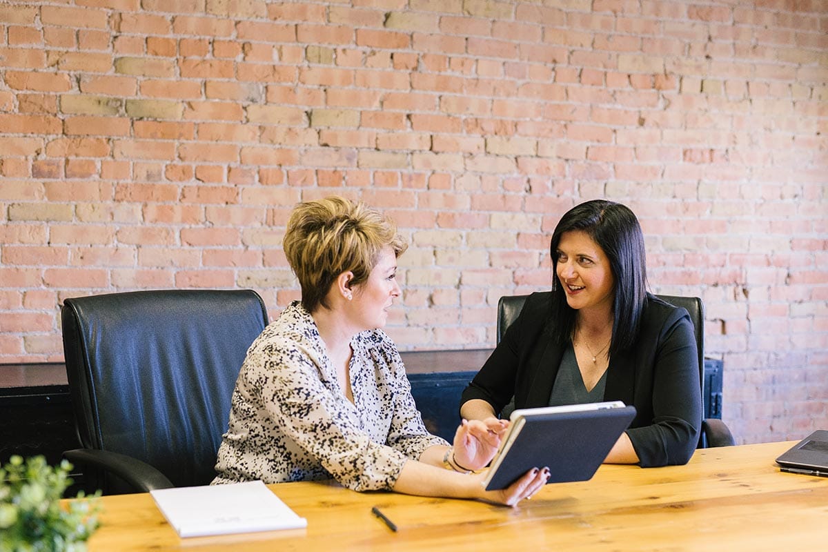 Two women talking at a conference table