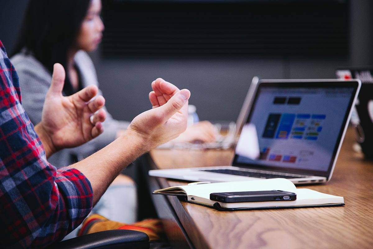 Man's hands during a conversation at a conference table