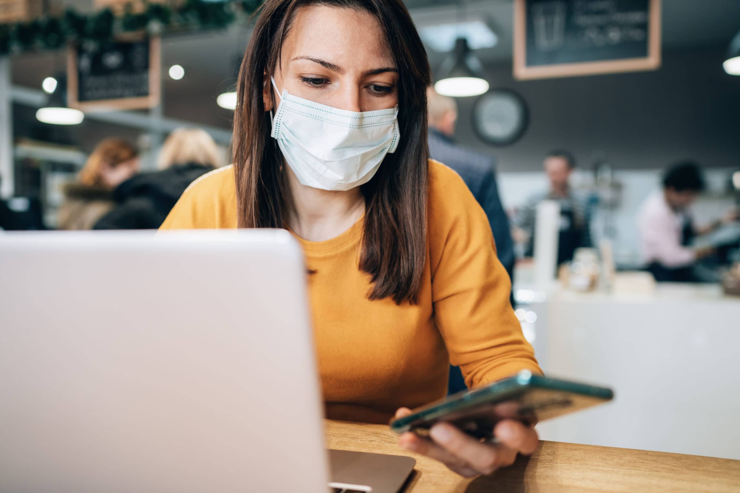 Woman with face protective mask calling phone