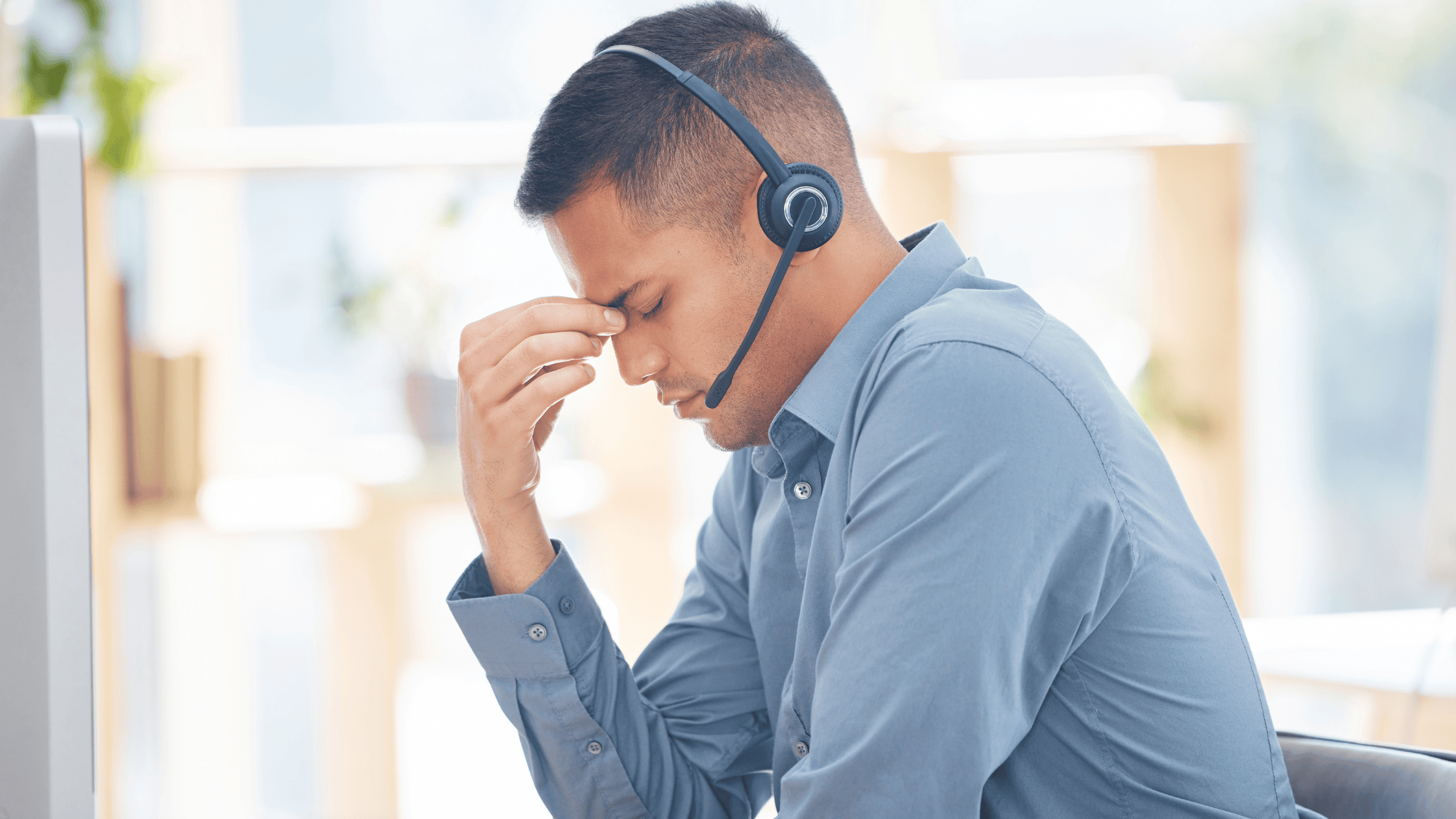 Frustrated sales rep wearing a headset, highlighting burnout from overloaded outreach